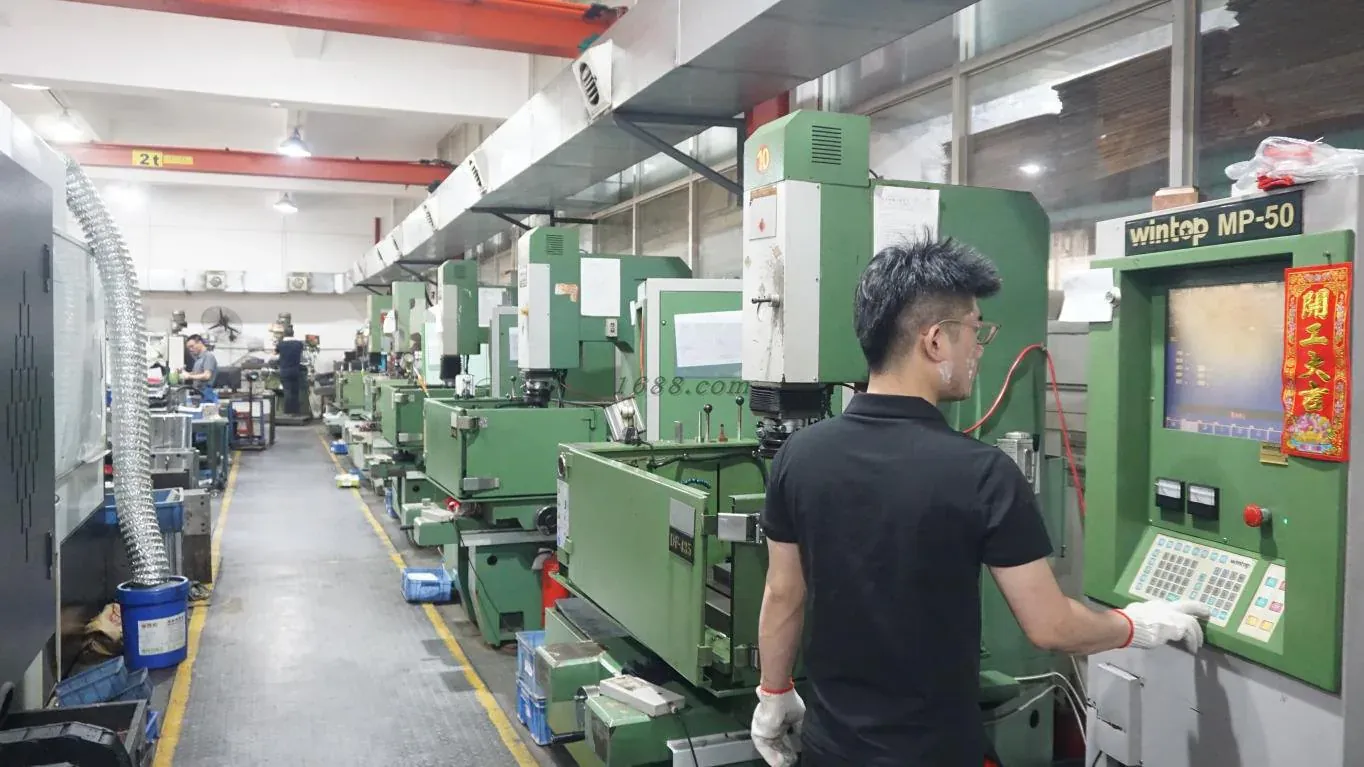 Operator working with precision EDM machines in a tooling workshop